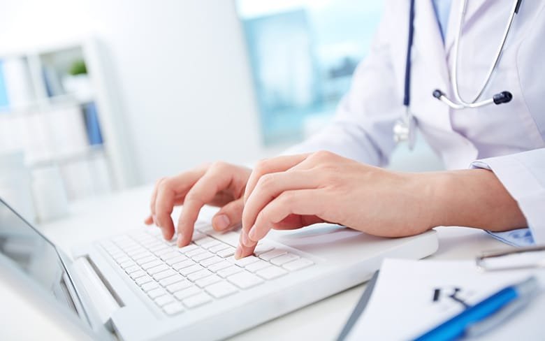 Doctor is Using his Laptop