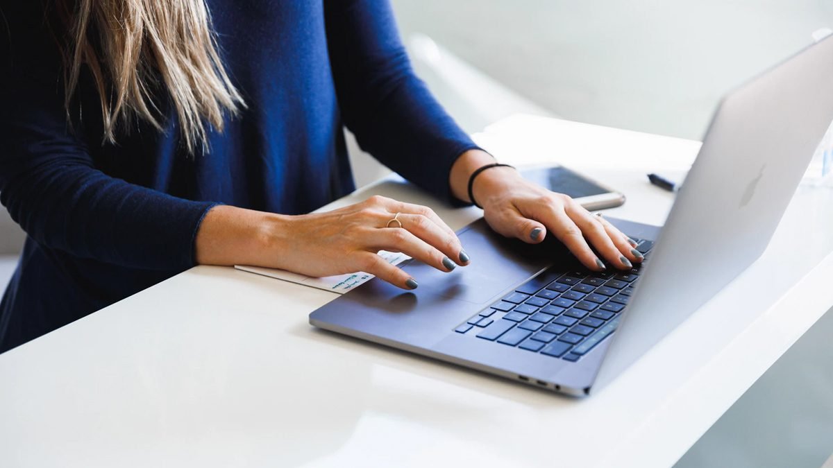 A Woman Writing Blog Post On The Laptop
