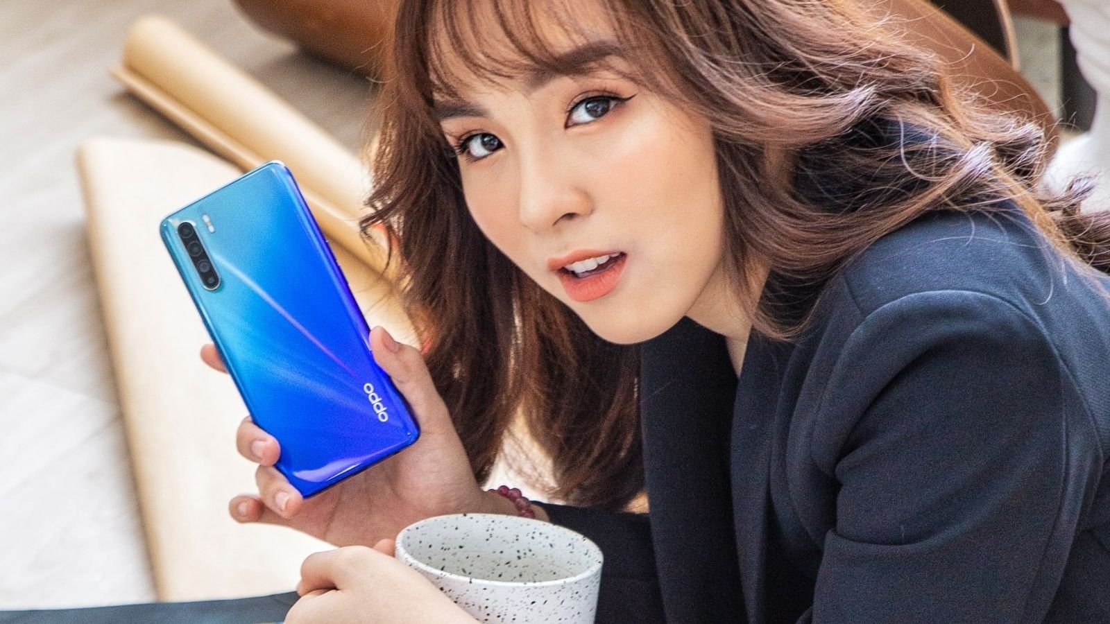 Model Holding Oppo Smartphone