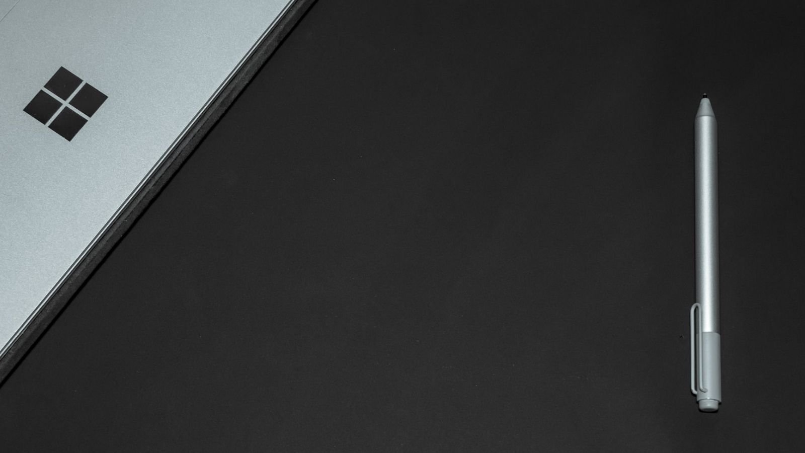 A Windows Laptop Alongside Pen