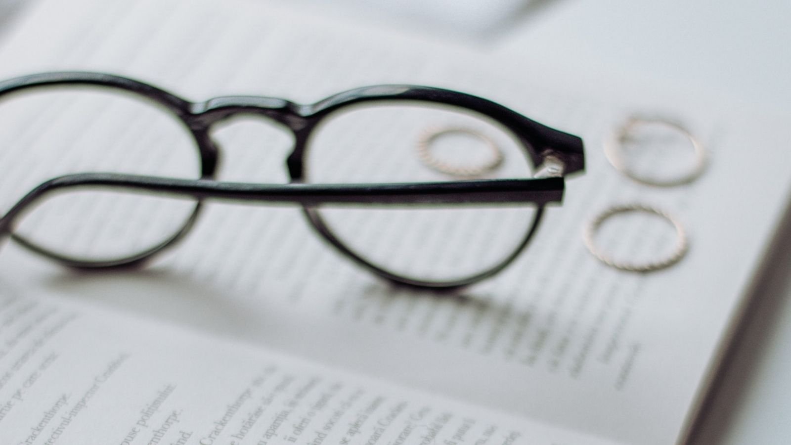 Ring And Glasses On A Book